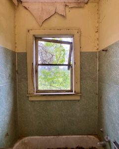 abandoned farmhouse bathroom window