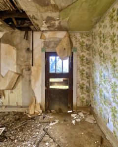 abandoned farmhouse living room front door green wallpaper