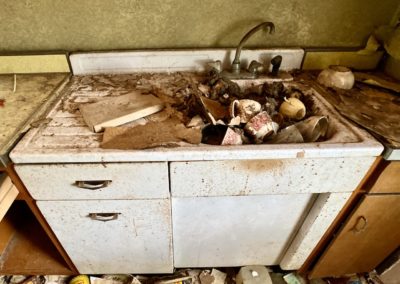 abandoned house with dishes still in the sink