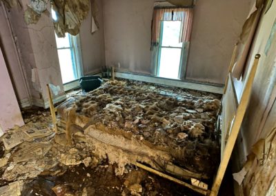 abandoned bed rotting away in a farmhouse