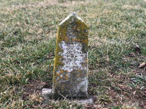 abandoned cemetery in ohio with small pointed tombstone