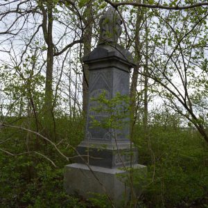 abandoned cemetery monument overgrown and forgotten
