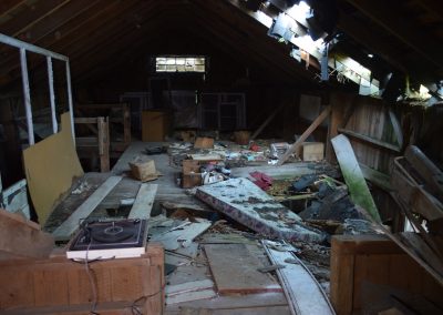 upstairs of abandoned barn with floor caving in