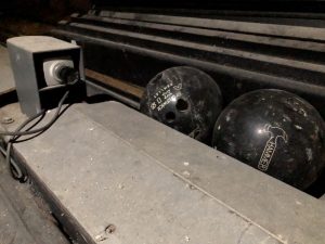 abandoned bowling lane camera with balls