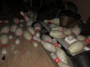 abandoned bowling pins in pile