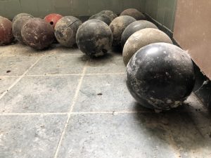 broken bowling balls covered in dust