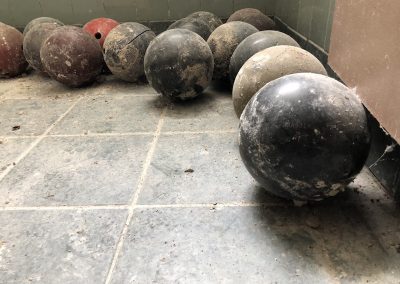 broken bowling balls covered in dust