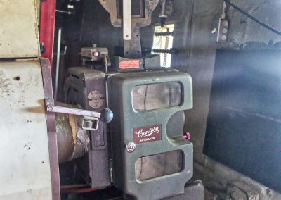 vintage projector inside abandoned drive in movie theater