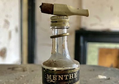 menthe bottle abandoned building