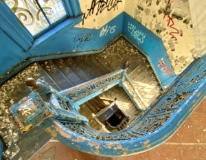 abandoned school blue staircase round looking down