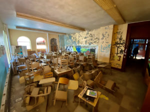 room of desks abandoned catholic school