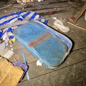 abandoned blue stripe suitcase vintage