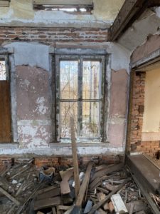 abandoned farmhouse window open in center
