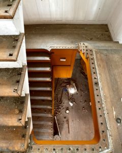 looking down the stairs of an abandoned house