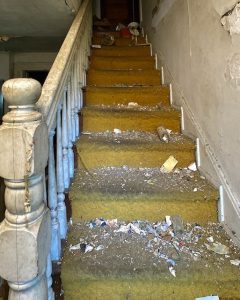 abandoned-victorian-house-white-staircase-orange-carpet
