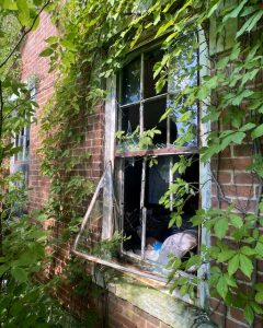 abandoned victorian mansion front window