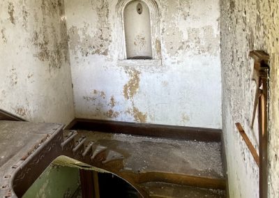 abandoned victorian mansion top of stairs