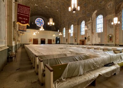 abandoned church pews covered with plastic