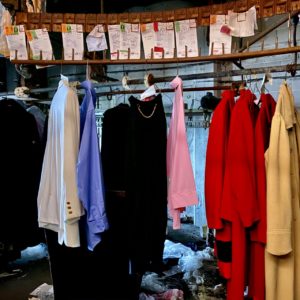 clothes still hanging at abandoned dry cleaner