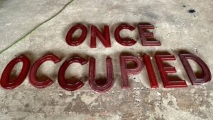 red-marquee-letters-on-the-floor-once-occupied