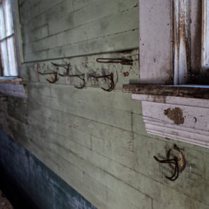 abandoned schoolhouse coat hooks