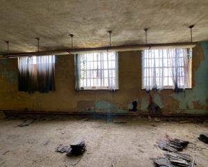 abandoned school basement room with curtains