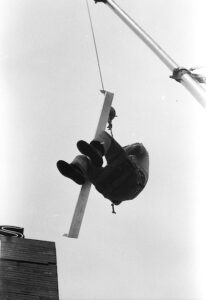 man-swinging-from-crane-1940s